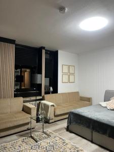 a living room with a bed and a couch at Domblick Apartment in Aachen