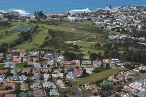 an aerial view of a town with houses and the ocean at Seaside Hermanus Guest Room in Hermanus
