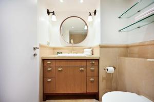 a bathroom with a sink and a mirror at (Floor Shelter)Luxury Sea View w/Pool Inside Hotel in Tel Aviv +26 photos