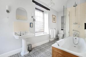 a bathroom with a sink and a tub and a toilet at The Moonraker Hotel in Bradford on Avon +51 photos