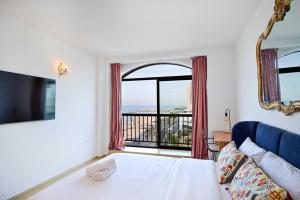 a bedroom with a bed and a large window at (Floor Shelter)Luxury Sea View w/Pool Inside Hotel in Tel Aviv