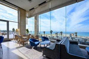 a large room with a view of the ocean at (Floor Shelter)Luxury Sea View w/Pool Inside Hotel in Tel Aviv