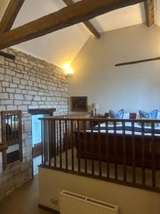 a room with a staircase and a brick wall at The Moonraker Hotel in Bradford on Avon