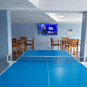a blue ping pong table in a room with chairs at Clearwater Beach Pelican 2 in Clearwater Beach