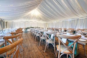 a long dining room with tables and chairs at The Moonraker Hotel in Bradford on Avon