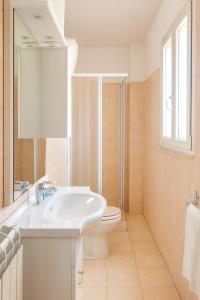 a white bathroom with a sink and a toilet at Hotel Ariston in Piombino +57 photos