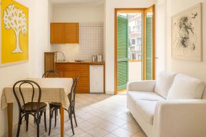 a living room with a table and a couch at Hotel Ariston in Piombino