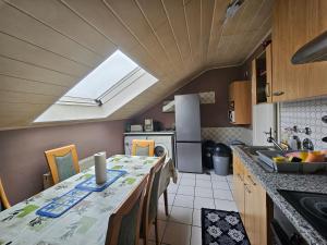 a kitchen with a table with chairs and a window at Appartements & Ferienwohnungen Wolf in Usingen