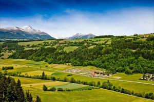 an aerial view of a green valley with mountains at Camping Bella Austria - Maeva Vacansoleil in Sankt Peter am Kammersberg