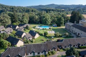 an aerial view of a house with a pool at VVF Château sur la Vienne Lac de Vassivière in Nedde
