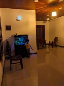 a little boy standing in front of a fish tank in a living room at Villa 505 Induruwa in Induruwa