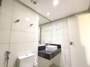 a bathroom with a sink and a toilet at Hotel JD in Taquaritinga do Norte