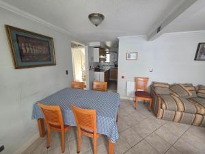 a dining room with a table and chairs and a bed at Maitencillo Habitamar in Maitencillo