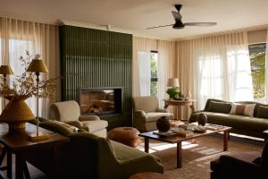 a living room with a couch and a fireplace at The Manor House at Colmant in Franschhoek
