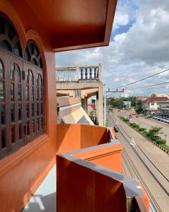 a balcony of a building with a view of a street at Zhejiang Pakxe Hotel in Pakse +4 photos