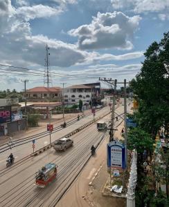 a busy city street with cars on a road at Zhejiang Pakxe Hotel in Pakse