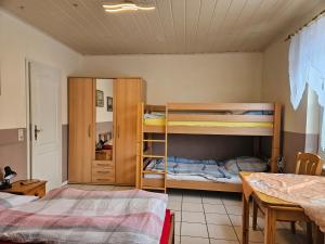 a room with two bunk beds and a table at Appartements & Ferienwohnungen Wolf in Usingen