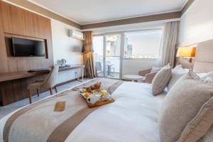 a hotel room with a bed with a tray of food on it at Kenzi Basma in Casablanca +118 photos