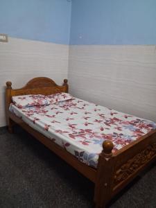 a bed sitting in a room with at Bhavadesh Lodge in Virudunagar
