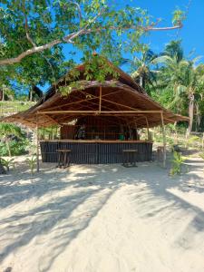 a hut with a straw roof on the beach at Tress Maria's beach resort in Brother Islands