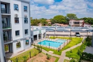 an aerial view of a building with a swimming pool at Lerako Apartment in Gaborone