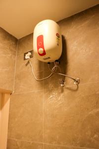 a blow dryer on the wall of a bathroom at Le Sara's Nest in Pondicherry +22 photos
