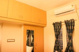 a room with black curtains and a window at Le Sara's Nest in Pondicherry