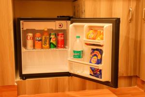 an open refrigerator filled with drinks and drinks at Le Sara's Nest in Pondicherry