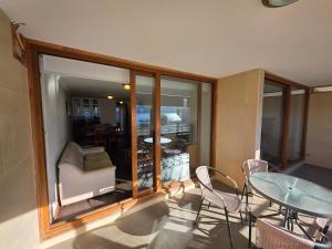 a room with a table and chairs and a table and a glass table at Departamento Lago Vichuquen in Vichuquén Lake