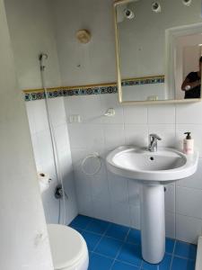 a bathroom with a sink and a toilet and a mirror at Appartamentino Bianco in Rio Marina +9 photos