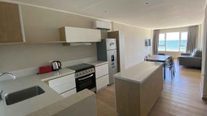 a kitchen and living room with a view of the ocean at Oceano in Necochea
