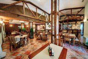 a restaurant with tables and chairs in a room at Oak Residence Hotel & Relax in Smolyan