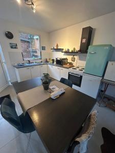 a kitchen with a table and a counter top at Steves place Temse in Sint-Niklaas