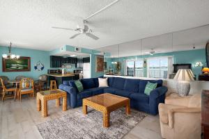 a living room with a blue couch and a table at Crab Cove 302 in Ocean City