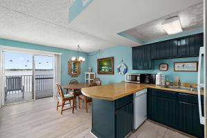 a kitchen with a table and a dining room at Crab Cove 302 in Ocean City