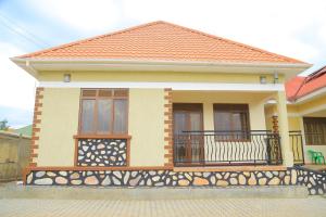 a small house with a balcony with a fence at Celesta House in Mbarara