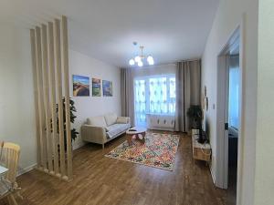 a living room with a couch and a table at Zolu apartment in Ulaanbaatar +8 photos
