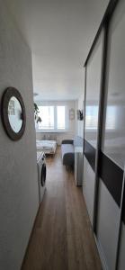 a small room with a bed and a mirror at Apartmán Horizont Martin-Sever in Martin