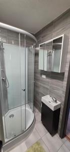 a bathroom with a shower and a sink at Apartmán Horizont Martin-Sever in Martin