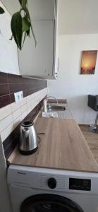 a kitchen with a counter top and a microwave at Apartmán Horizont Martin-Sever in Martin