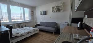 a small living room with a couch and a chair at Apartmán Horizont Martin-Sever in Martin