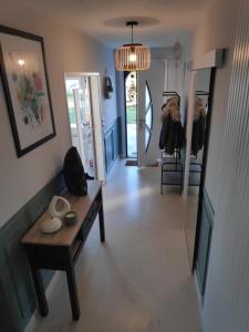 a living room with a table and a hallway at Kastell-Mor 2 chambre d'hôtes à Santec in Santec