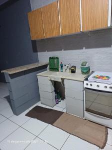 a toy kitchen with a counter and a stove at KitNet a caminho da ILHA DO MEL in Pontal do Paraná +9 photos