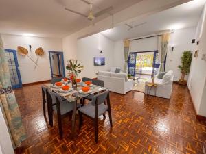 a living room with a table and chairs and a couch at Attalah Beach Cottage in Mombasa