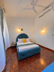 a bedroom with a large bed in a room at Attalah Beach Cottage in Mombasa