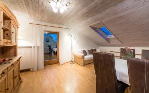 a kitchen and living room with a bed and a table at Residence Fischerhof in Tirolo