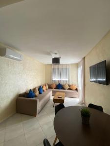a living room with a couch and a table at Appartement OCEANICA RESIDENCES in Marina Smir