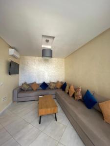a living room with a couch and a table at Appartement OCEANICA RESIDENCES in Marina Smir