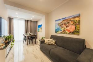 a living room with a couch and a table at NEW - Only Suites Unit 6 - Modern 2-Bedroom apartment with common heated Jacuzzi by SF Homes in St. Julianʼs
