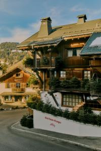 a large wooden house on the side of a street at Hôtel Saint-Georges Relais & Châteaux in Megève